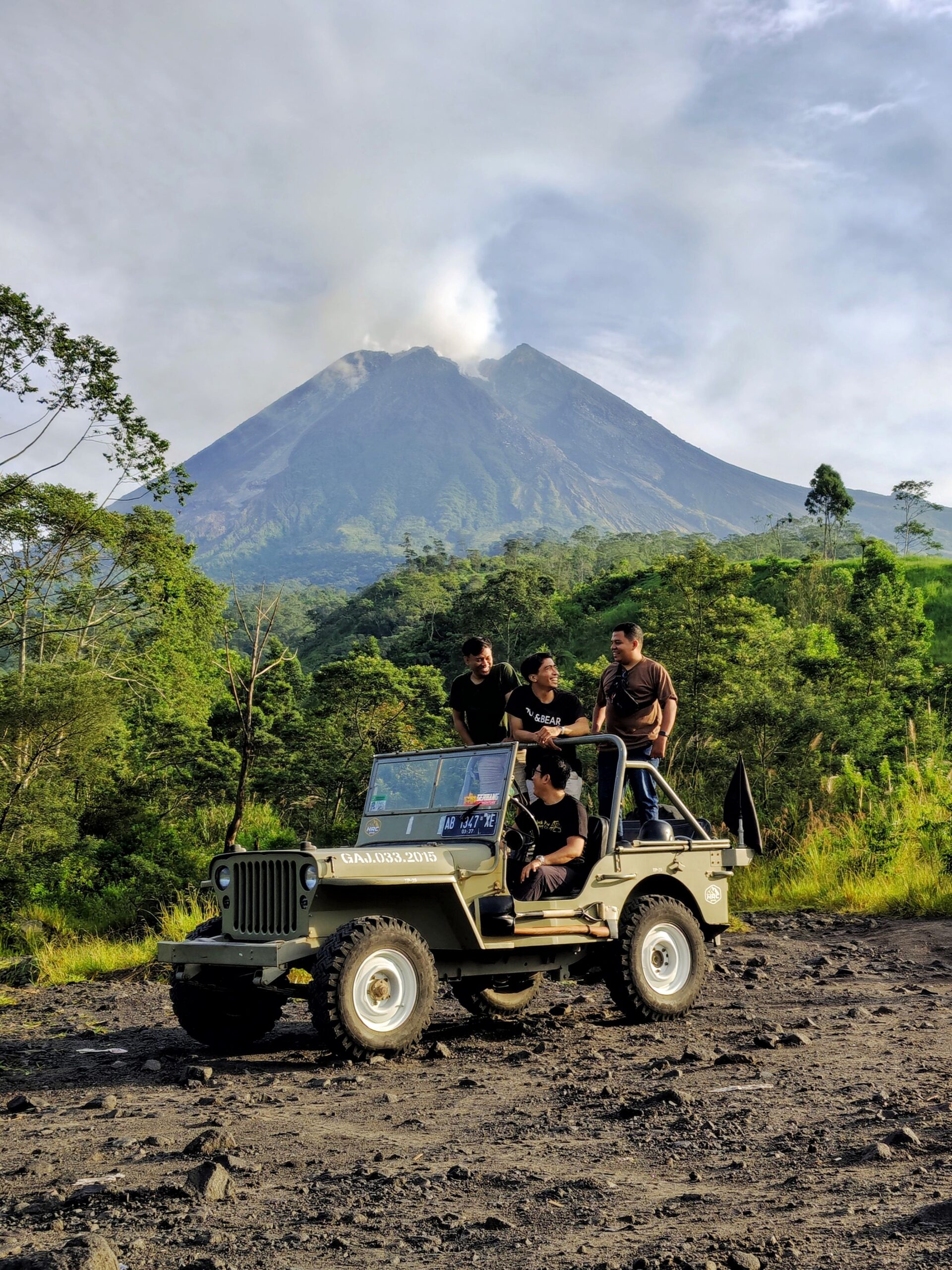 Group enjoying an off-road adventure near Mount Merapi volcano, surrounded by lush greenery.